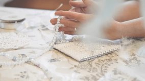 Woman making dreamcatcher from threads, feathers, beads and silk ribbons, making home decor items, handmade amulet - Powered by Shutterstock - Get 15% off with code: PIKWIZARD15