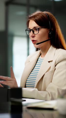 Efficient Customer Care: Smiling Call Center Agent In Busy Office Providing Excellent Service Through Headset For Sales Support