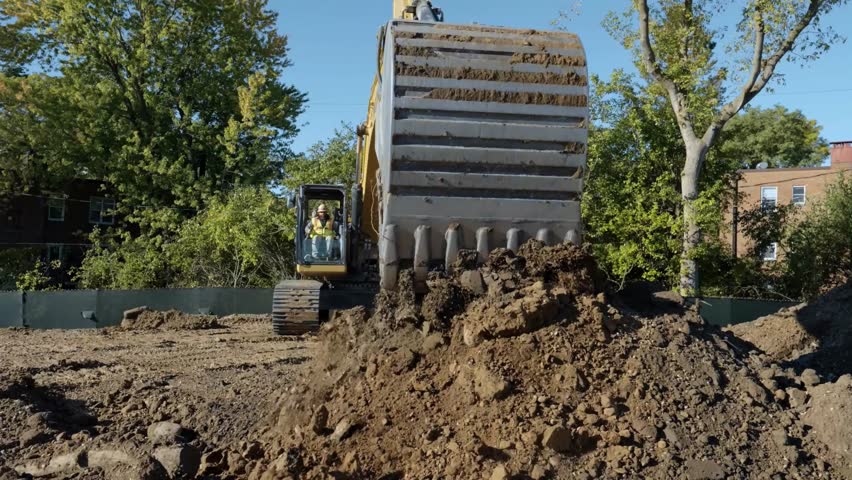 An excavator is working on a construction site, highlighting its key role in development