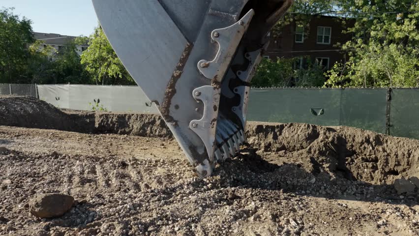 excavator digging earth in slow motion. excavator bucket work on construction site