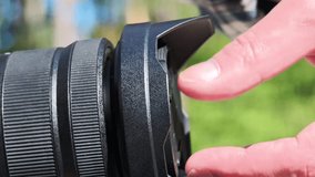 Closeup of photographer removing lens hood from camera lens - Powered by Shutterstock - Get 15% off with code: PIKWIZARD15