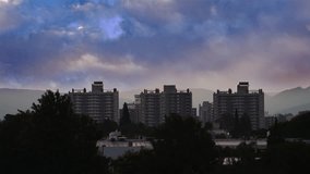 Hazy cityscape with high-rise buildings and full moon - Powered by Shutterstock - Get 15% off with code: PIKWIZARD15
