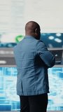 Vertical Video Black IT engineer working in a digital environment with programming language and data science algorithm. Specialist reviews code development, automation and innovation. Coding life - Powered by Shutterstock - Get 15% off with code: PIKWIZARD15