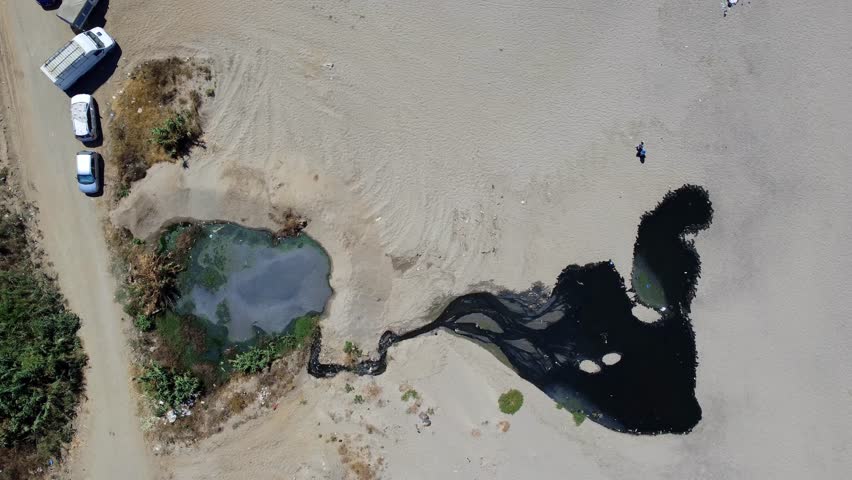 Aerial view of beach sewer wastewater pipe in water sea enviroment nature protection damage pollution sea ocean concept, Wastewater pollution of sea ecosystem, danger of swimming in dirty sea water.
