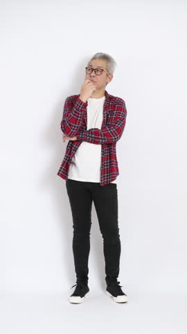 The elderly East Asian man wearing a red plaid shirt is standing against a white background.