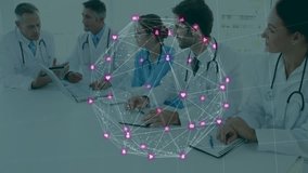 Senior doctor holding tablet explaining data, team planning care, pink heart icons growing on table. Collaboration, teamwork, healthcare, digital, innovation, professionalism, communication - Powered by Shutterstock - Get 15% off with code: PIKWIZARD15