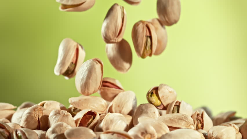 Super Slow Motion Shot of Falling Pistachio Nuts on Gradient Background at 1000fps.
