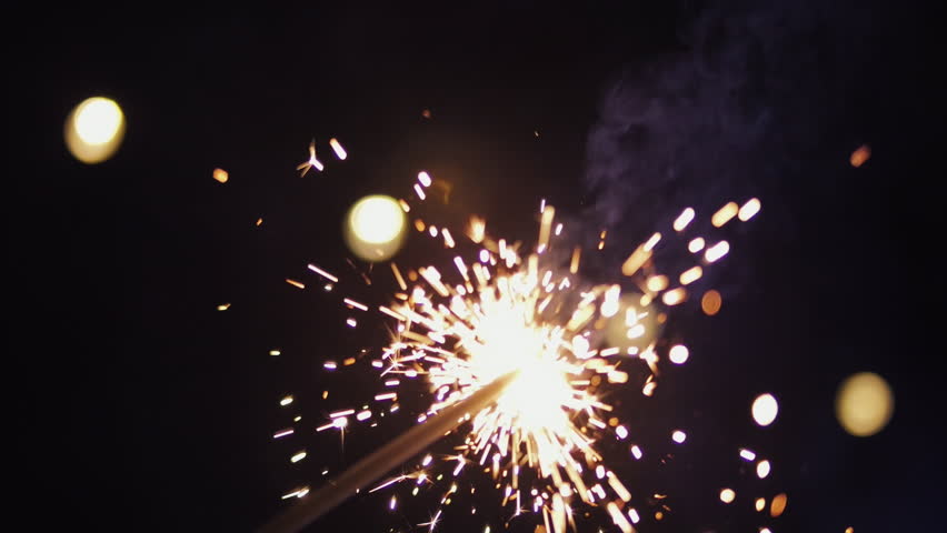 Hand Holding Sparkler with Glowing Lights