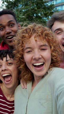 Group of students smiling and taking selfie in slow motion. Multi-ethnic students taking a selfie together, smiling and looking at camera
