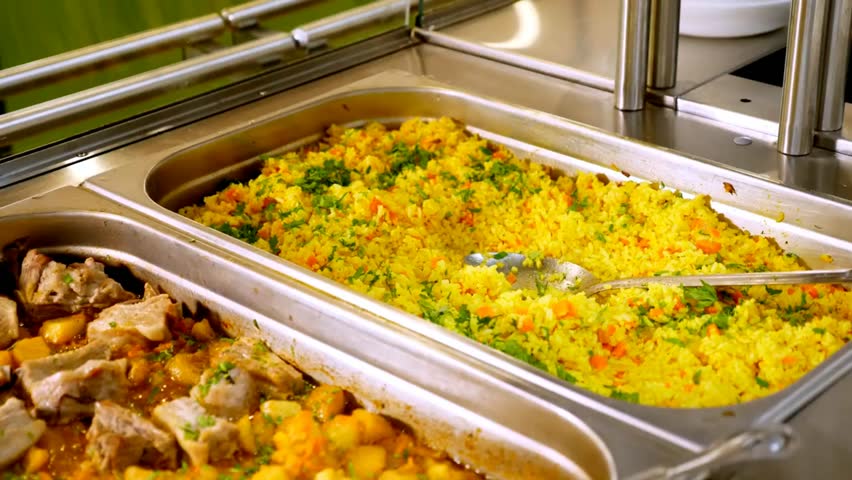 Close-up of a vibrant lunch buffet with assorted dishes, fresh salads, and hot meals in trays. Perfect for food, catering, or restaurant themes.
