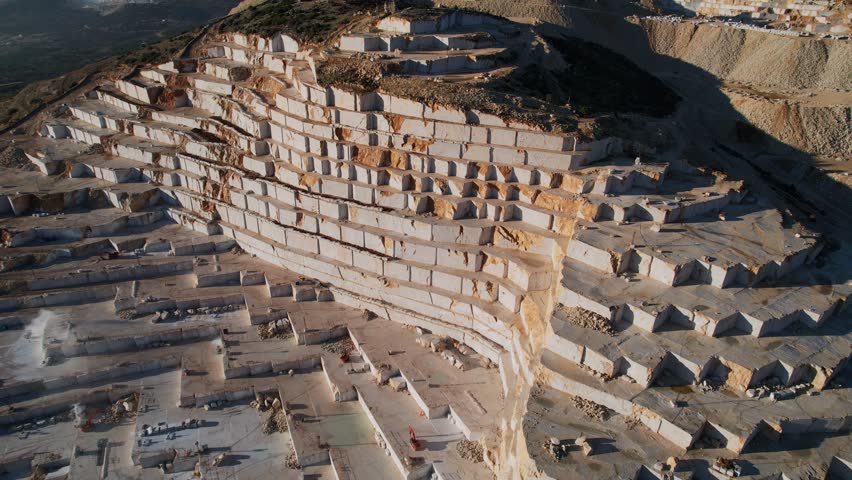 Aerial view Marble quarry and cut white blocks with Industry yellow track.