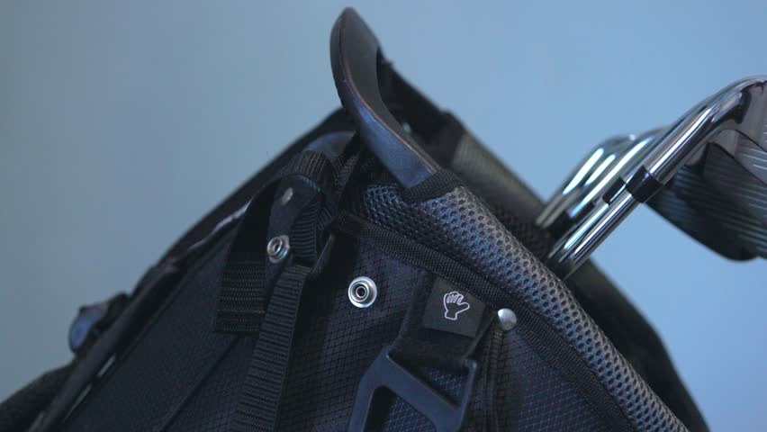 panning shot of brand new golf irons on display within a stand bag
