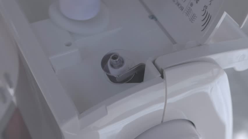 bobbin being filled with white thread ready to use on a sewing machine