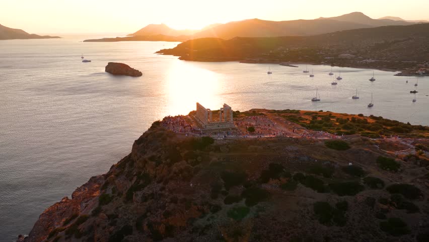 Aerial view of the Temple of Poseidon at Cape Sounion at the edge of Attica, Greece, during a beautiful summer sunset