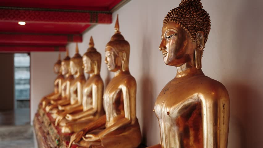 Golden buddha statues inside ornate wat pho temple interior, highlighting sacred spiritual environment of iconic Bangkok buddhist landmark, Thailand