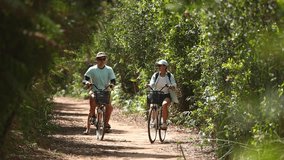 Happy caucasian family on bike ride in park. Happy family travel and vacations. Outdoors activity.  - Powered by Shutterstock - Get 15% off with code: PIKWIZARD15