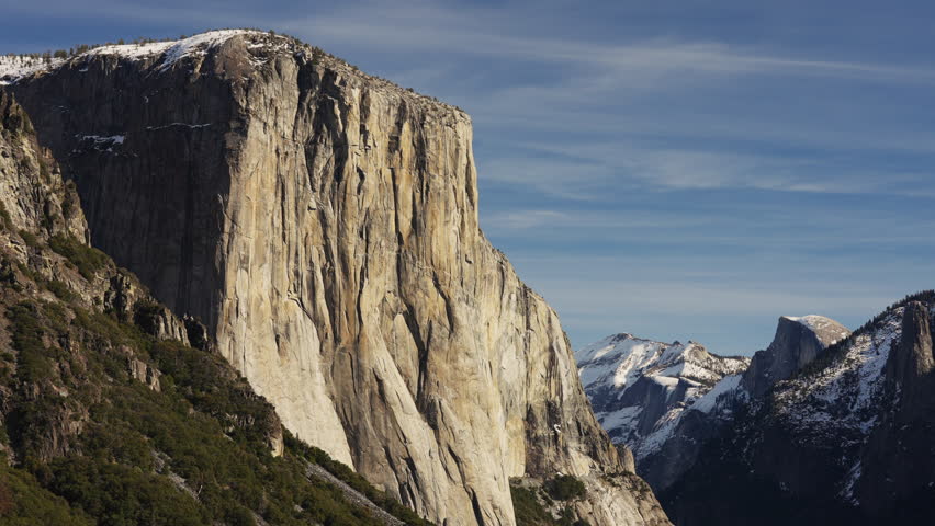 El Capitan vertical rock formation covered partially in snow showing Half Dome in the background with the mountains near Yosemite valley tunnel view, Yosemite national park 