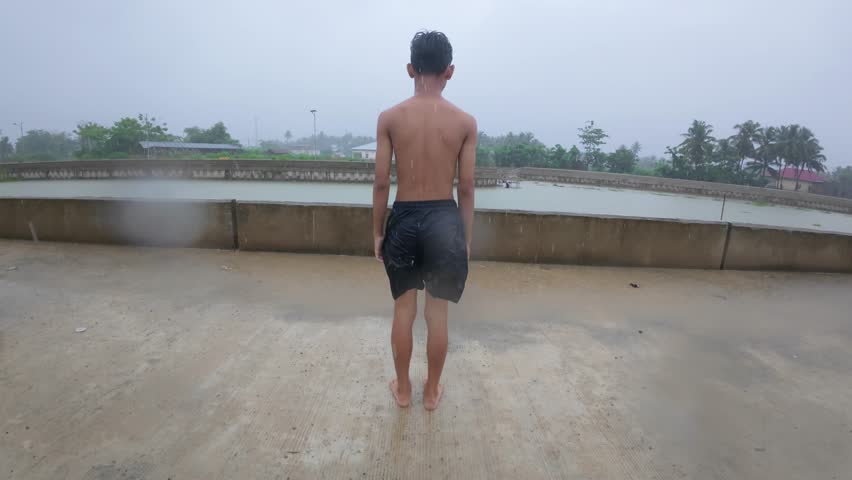 Boy Jumping into the River on Summer Day