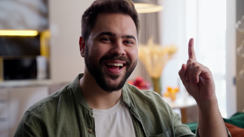 Pondering thinking happy creative adult bearded Caucasian business man male guy businessman homeowner thinker deep thoughts answer problem solution brainstorm having idea gesture raised finger at home