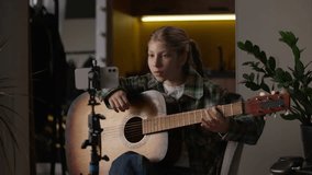 Caucasian little girl learning play guitar looking online tutorial mobile phone student talented child kid study song learn playing music watch lesson smartphone camera tripod teacher video call sing - Powered by Shutterstock - Get 15% off with code: PIKWIZARD15