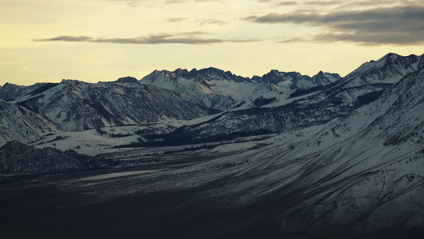 Sunset over the Sierra Nevada Mountains with its peaks covered in snow 