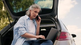 Angry shouting Caucasian elderly business woman car driver mad businesswoman female freelancer annoyed boss talking yelling mobile phone quarrel conflict work trouble typing laptop device outside park - Powered by Shutterstock - Get 15% off with code: PIKWIZARD15