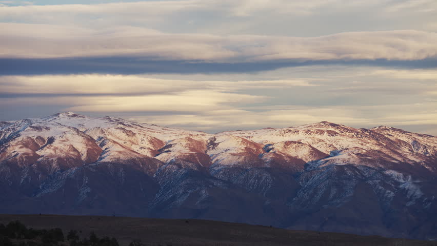 Sunset casting a shadow over the Eastern Sierra Nevada mountains peaks
