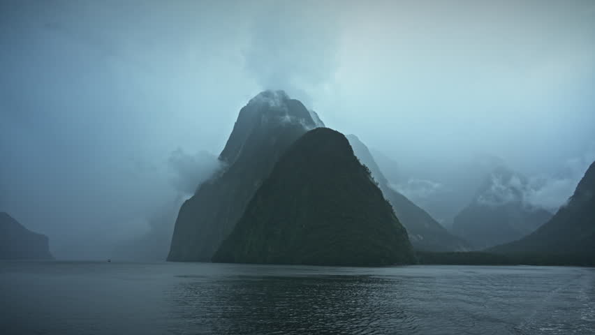 Dramatic landscape during cruise on Milfoard Sound with Mitre Peak in moody weather at Fiordland national park, New Zealand