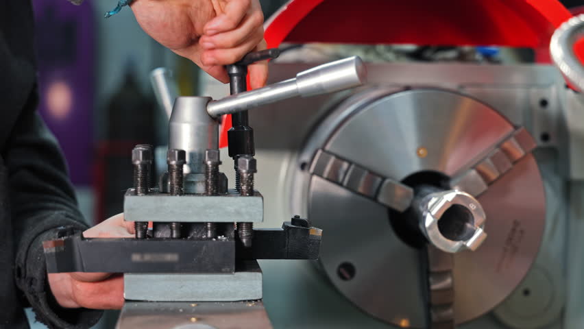 Metalworking Equipment Setup Process, Operator Adjusting Lathe Tool Holder for Precision Turning