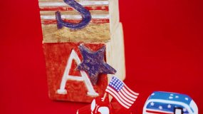 Flat lay of 4th of July celebration accessories including American flags, star-shaped sunglasses, patriotic hats, confetti, and red, white, and blue decorations on a vibrant background. - Powered by Shutterstock - Get 15% off with code: PIKWIZARD15