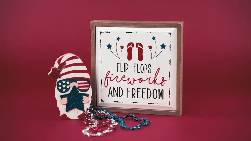 Flat lay of American flag, red-white-blue flip flops, fireworks, and text ‘Freedom’ on a vibrant, colorful background. A fun and festive Independence Day celebration Background