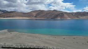 A stunning drone shot capturing a vivid blue lake cradled by majestic mountains, reflecting the sky’s hues and showcasing the untouched beauty of nature from a breathtaking aerial view.
 - Powered by Shutterstock - Get 15% off with code: PIKWIZARD15