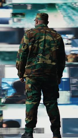 Vertical Video Armed forces officer monitoring satellite imagery to gather intelligence, collecting insight for war planning. African american man supporting mission control and global operations