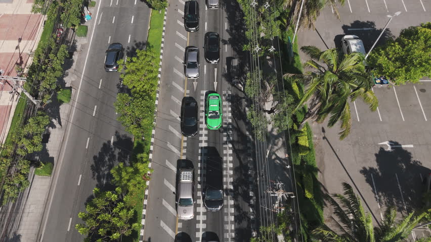 Traffic Jam On City Street Line With Palm Trees In Rama IV Road, Bangkok, Thailand. Aerial Drone Shot