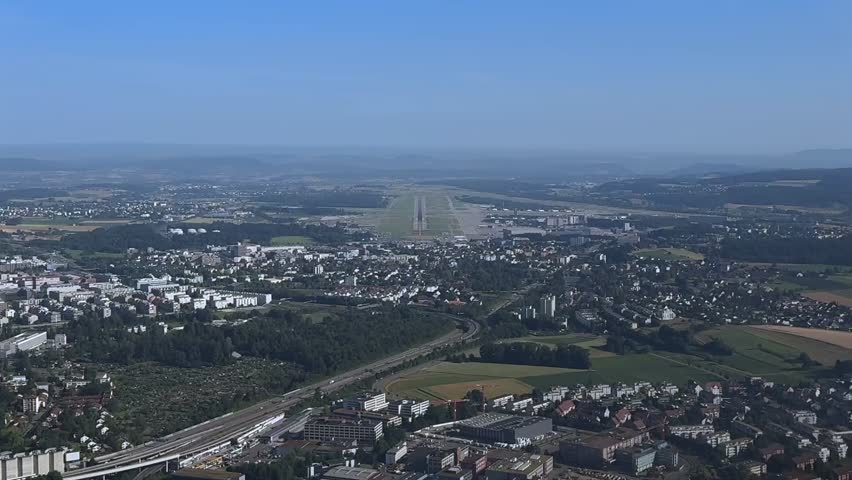 A Pilot vew of a real time approach to Zurich airport in a hazy summer morning. 4K