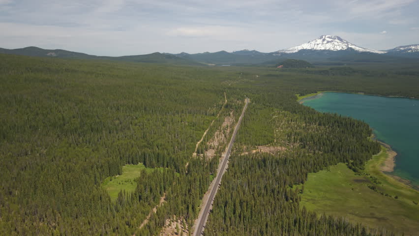 Lava Lake in Central Oregon at the Cascade Lakes Highway. Mount Bachelor, Broken Top and Sisters Mountains in the distance. Panoramic drone shot.