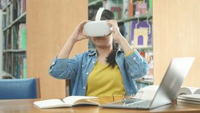 A woman uses a VR headset, immersed in a virtual experience while sitting in a library. Her gestures show engagement and interaction with the virtual environment. - Powered by Shutterstock - Get 15% off with code: PIKWIZARD15