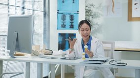 Portrait of an Asian female doctor using a smartphone in a hospital corridor, interacting with a virtual assistant or AI chatbot. She reviews health data via smart mirror technology, embracing future	 - Powered by Shutterstock - Get 15% off with code: PIKWIZARD15