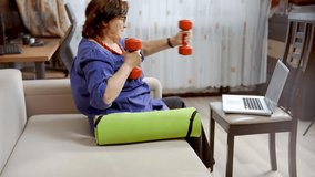 Senior woman lifting dumbbells at home. Active elderly lady doing fitness workout for healthy aging and wellness. Home training, healthy lifestyle, and sport recreation for older generation - Powered by Shutterstock - Get 15% off with code: PIKWIZARD15