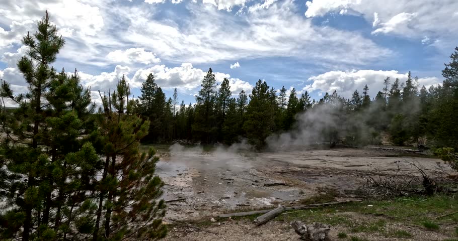 Minute Geyser (Hydrothermal Feature) Spouting, Splashing, And Steaming Near The Norris Geyser Basin Trail In Yellowstone National Park, USA. 4K Tourist POV From The Viewing Platform.