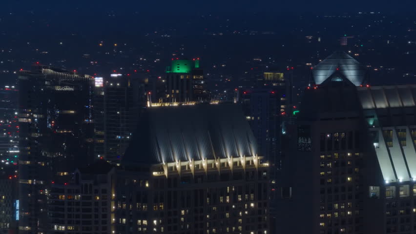 Enjoy stunning aerial views of Downtown San Diego at night, featuring illuminated skyscrapers, vibrant lights, and a captivating skyline that creates a mesmerizing urban landscape