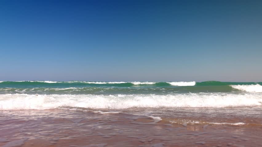 Waves in the Atlantic Ocean in Daytona Beach, Florida with low shot in slow motion.