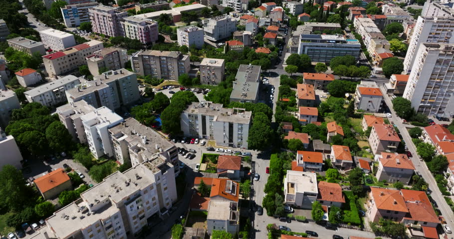 Modern Apartment Buildings In Coastal City Of Split In Croatia. Adriatic Sea Revealed In Background. aerial tilt-up shot
