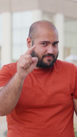Vertical Video of Bald indian Man Pointing and Showing Thumbs Up, Motivating