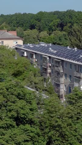 Video set: Solar panels on the roof of old Soviet apartment buildings. Solar power plant on the roof - vertical video