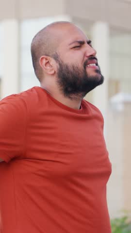 Vertical Video of Bald indian Man Back Pain