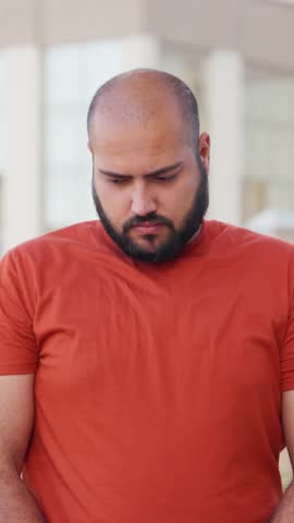 Vertical Video of Bald indian Man feeling Guilty