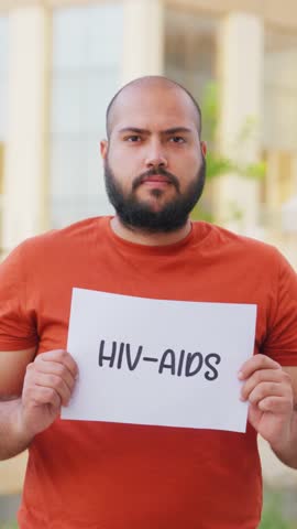 Vertical Video of Bald indian Man Holding HIV AIDS Poster