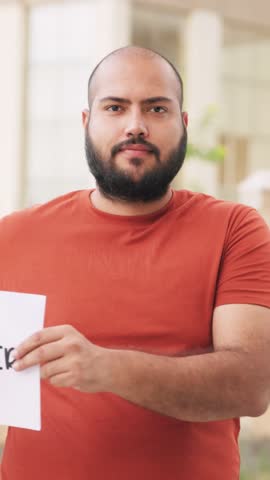 Vertical Video of Bald indian Man Holding Finfluencer Poster