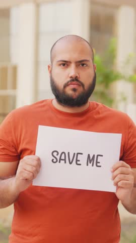 Vertical Video of Bald indian Man Holding Save Me Poster